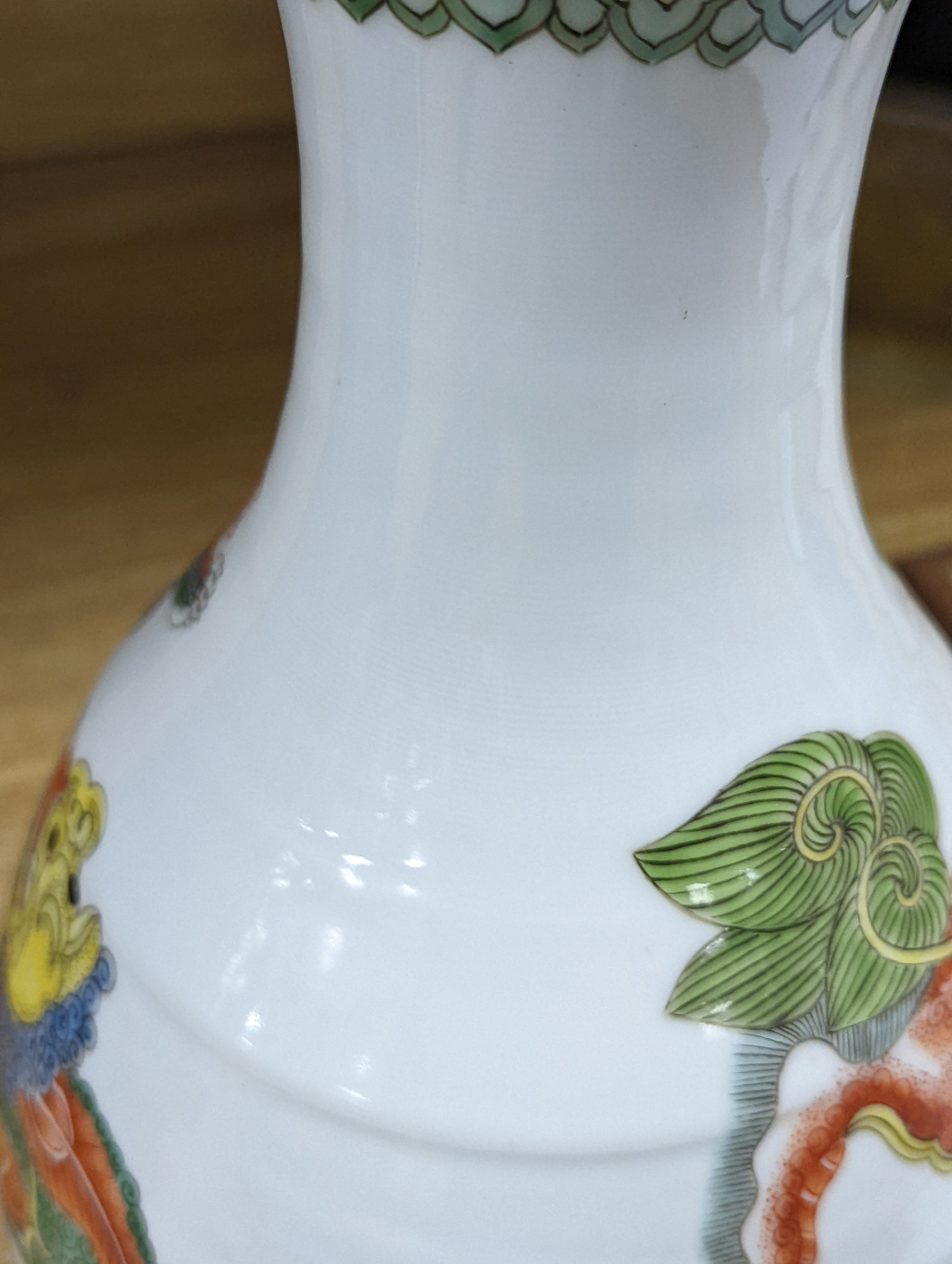 A Chinese famille verte pear shaped ‘Buddhist lion’ vase, on stand, 32 cms high not including stand.